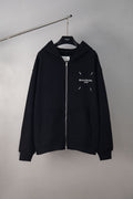 Black zip-up hoodie with hood and Maison Margiela chest logo