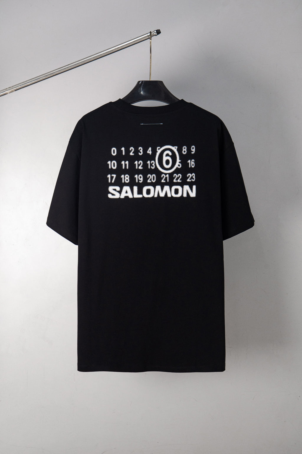 Black T-shirt with SALOMON graphic and number 6 print at chest