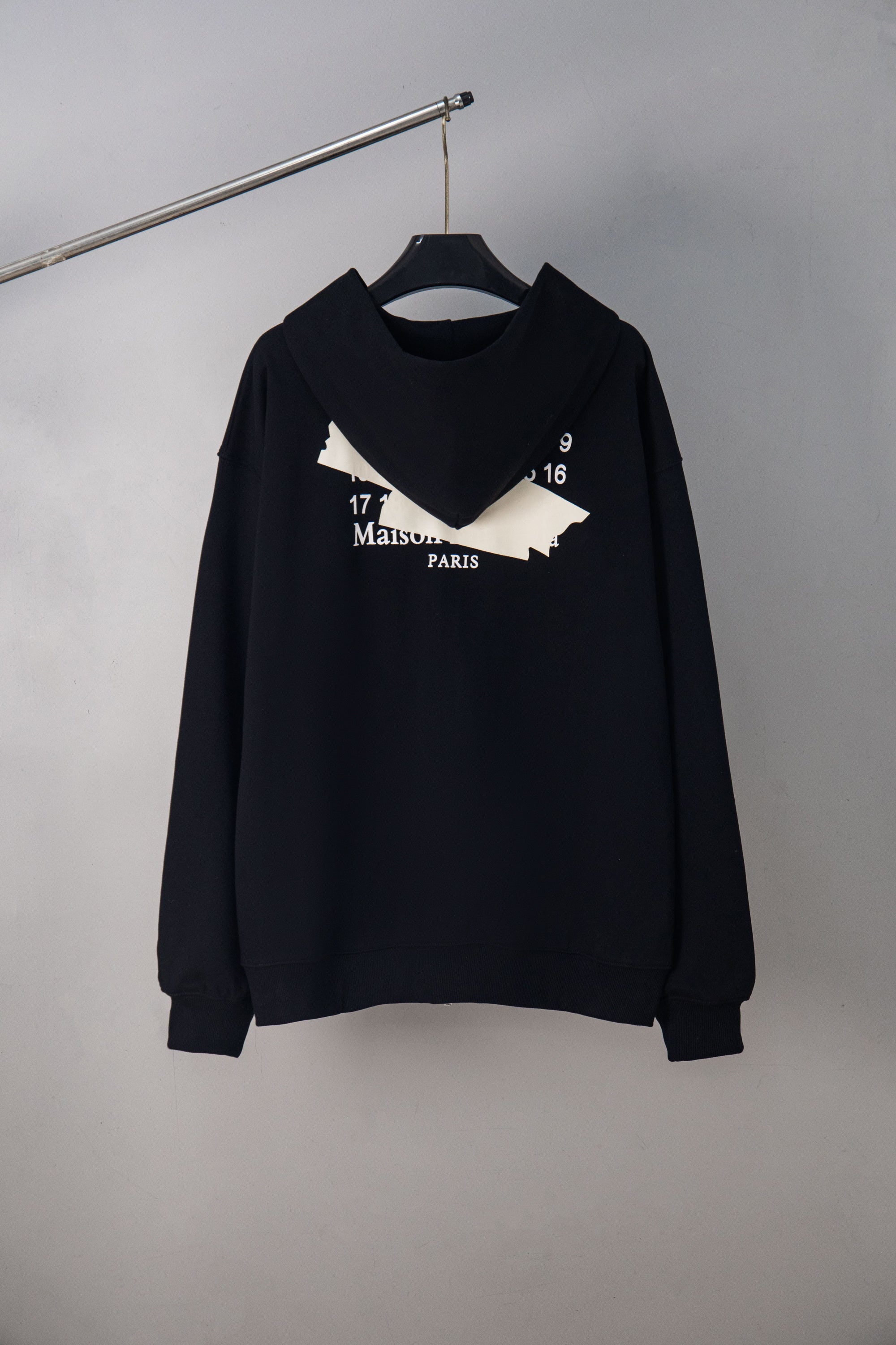 Black long-sleeve zip-up hoodie with graphic Maison Paris logo