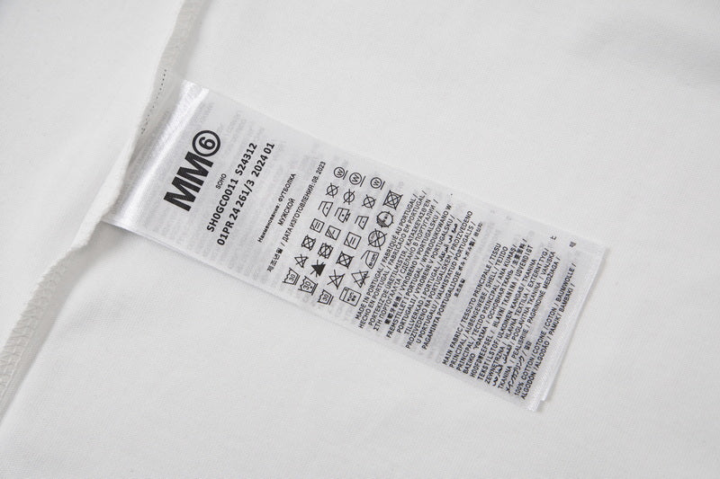 White fabric garment care label with size and washing instructions