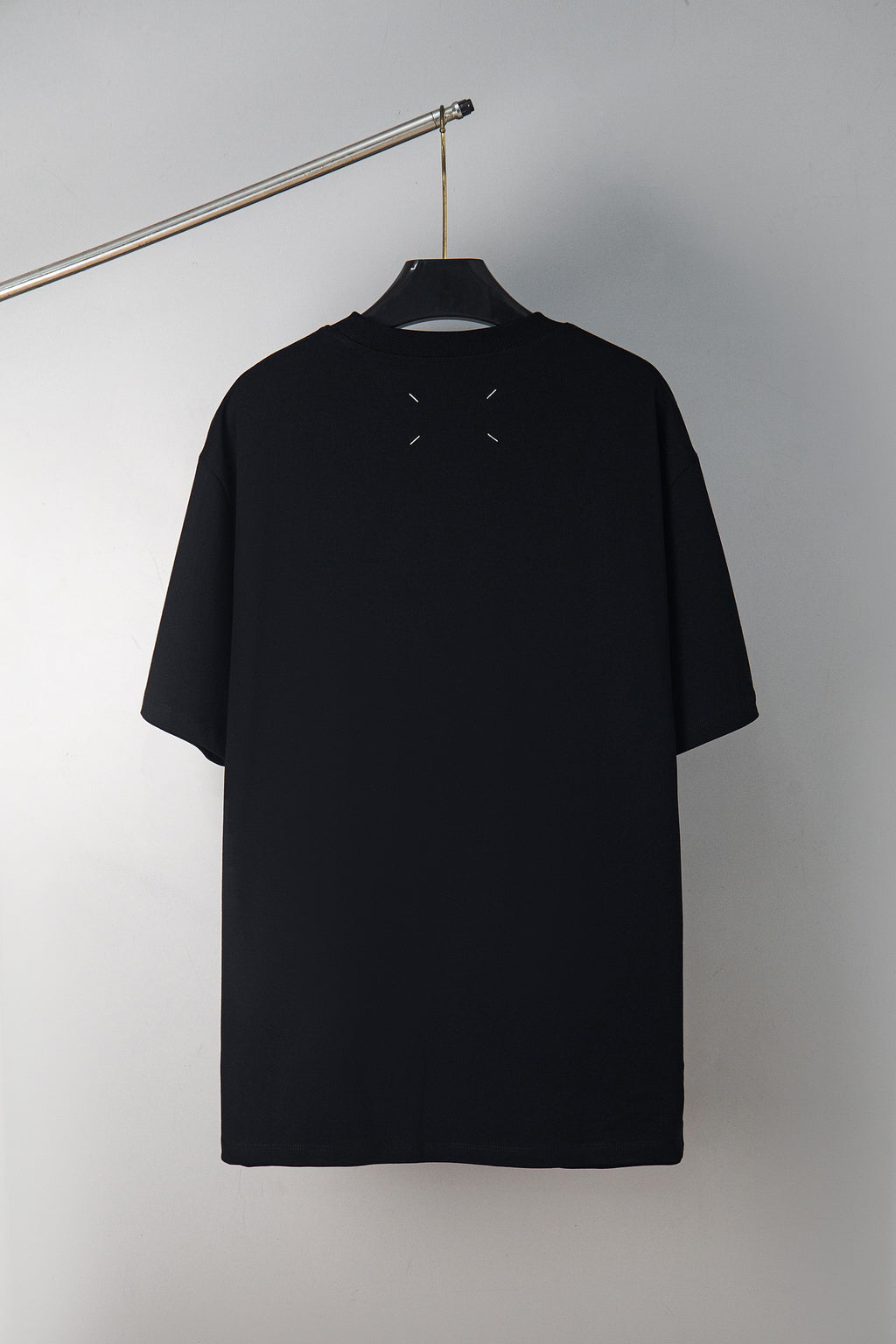 Black crewneck T-shirt with small dash graphic on upper back