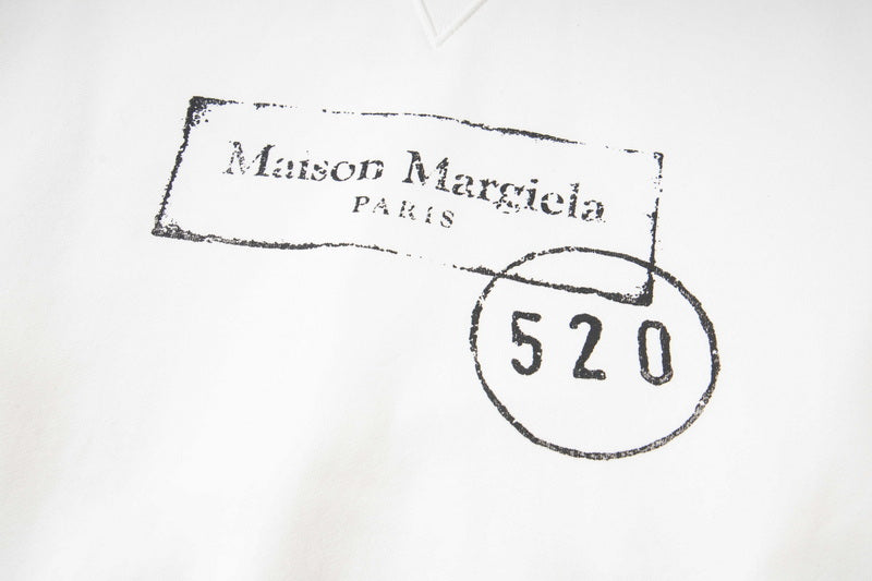 Close-up of Maison Margiela logo print with “520” on hoodie fabric.