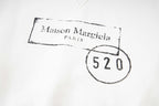 Close-up of Maison Margiela logo print with “520” on hoodie fabric.