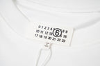 Maison Margiela collar label with circled 6 logo and number grid