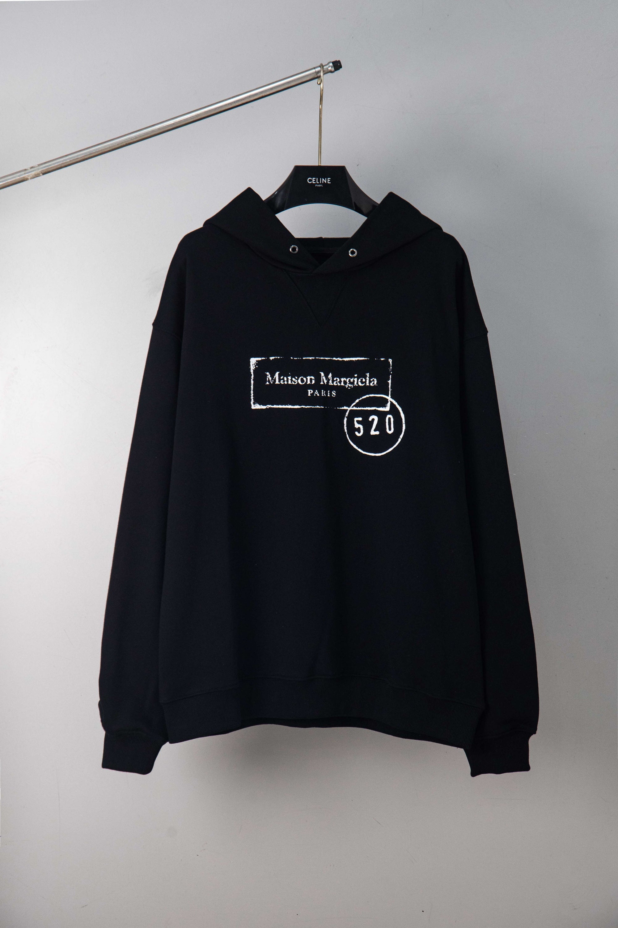 Maison Margiela pullover hoodie in dark, with hood and front kangaroo pocket.