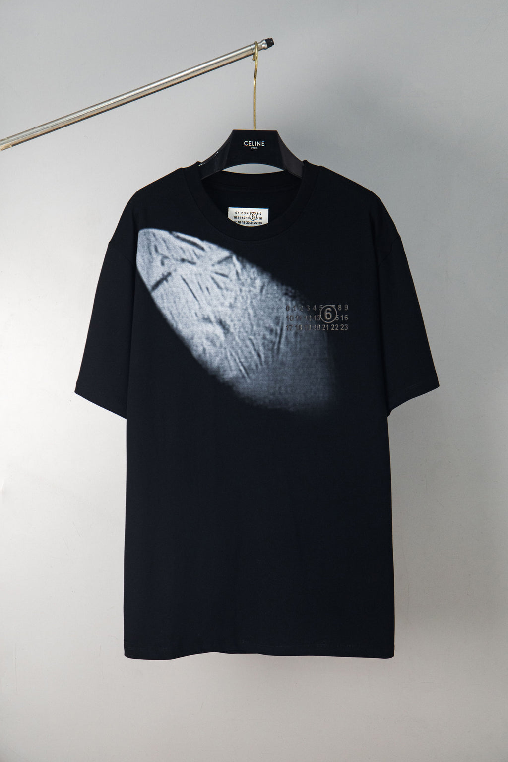 Black crewneck T-shirt with angled light-gray chest print