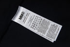 Close-up of black T-shirt care label with barcode and icons