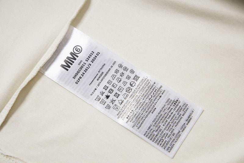 Cream T-shirt with brand care label at the neckline