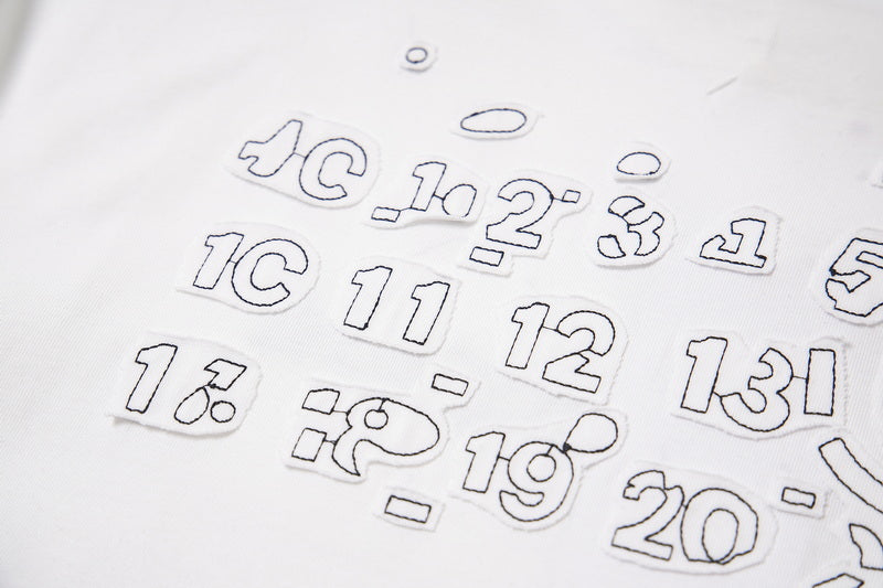 Close-up of gray numeric-style graphic print on T-shirt