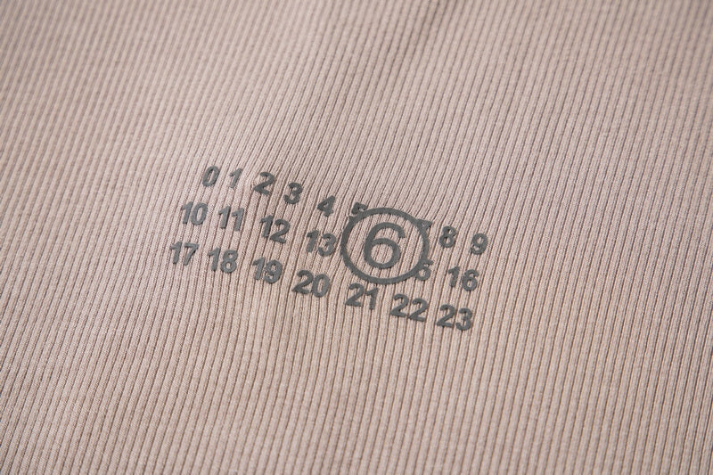 Beige ribbed knit fabric with circular logo print