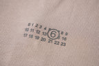 Beige ribbed knit fabric with circular logo print