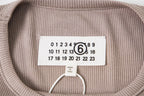 Beige T-shirt neck label with size numbers and Maison Margiela branding