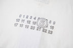 Light fabric T-shirt close-up of outlined number 6 and digits graphic