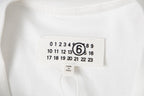 T-shirt neck label tag with size and brand details; number 6 graphic