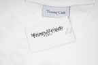 White T-shirt neckline with Tommy Cash label and care tag