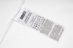 White T-shirt care label with MM6 text and symbols