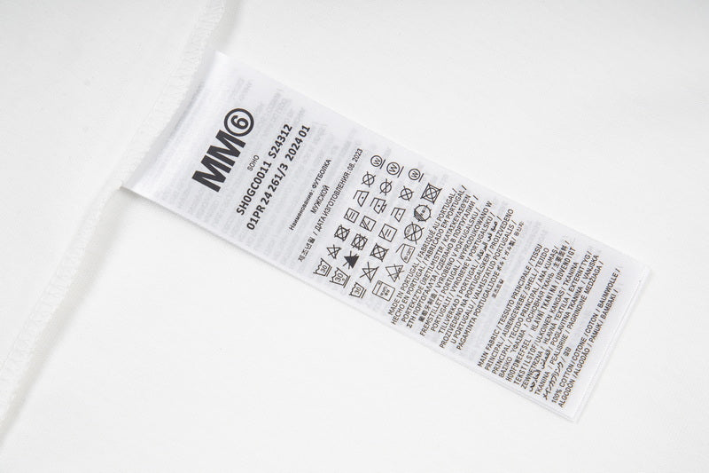 White T-shirt care label with MM6 text and symbols