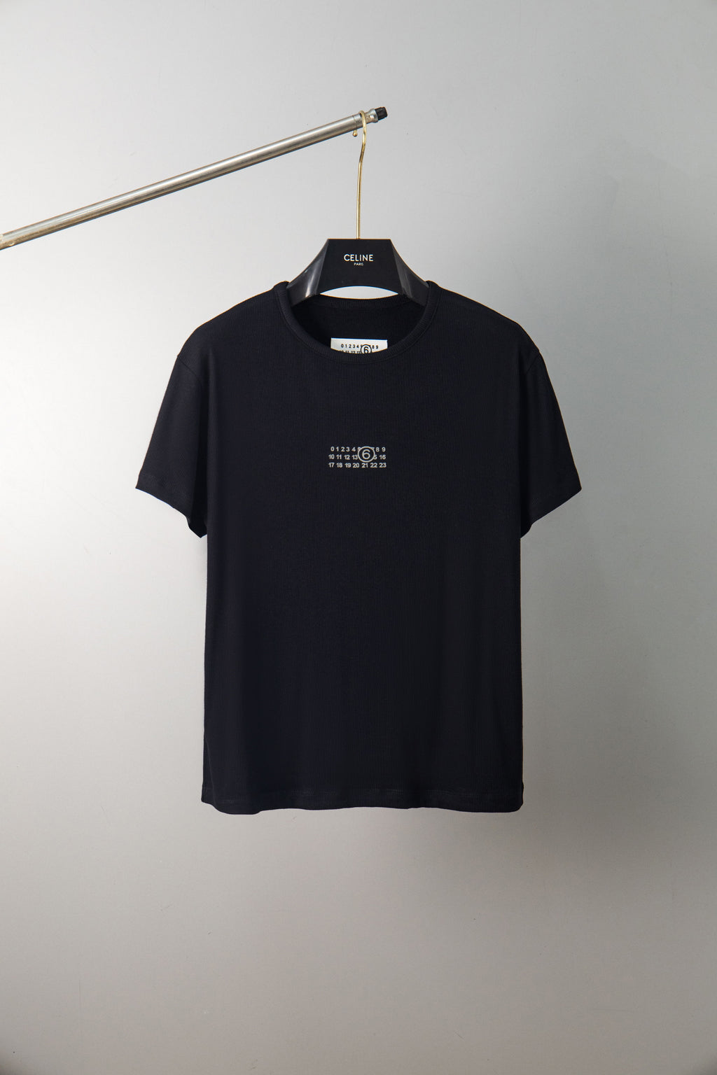 Black crew-neck T-shirt with small chest graphic, short sleeves