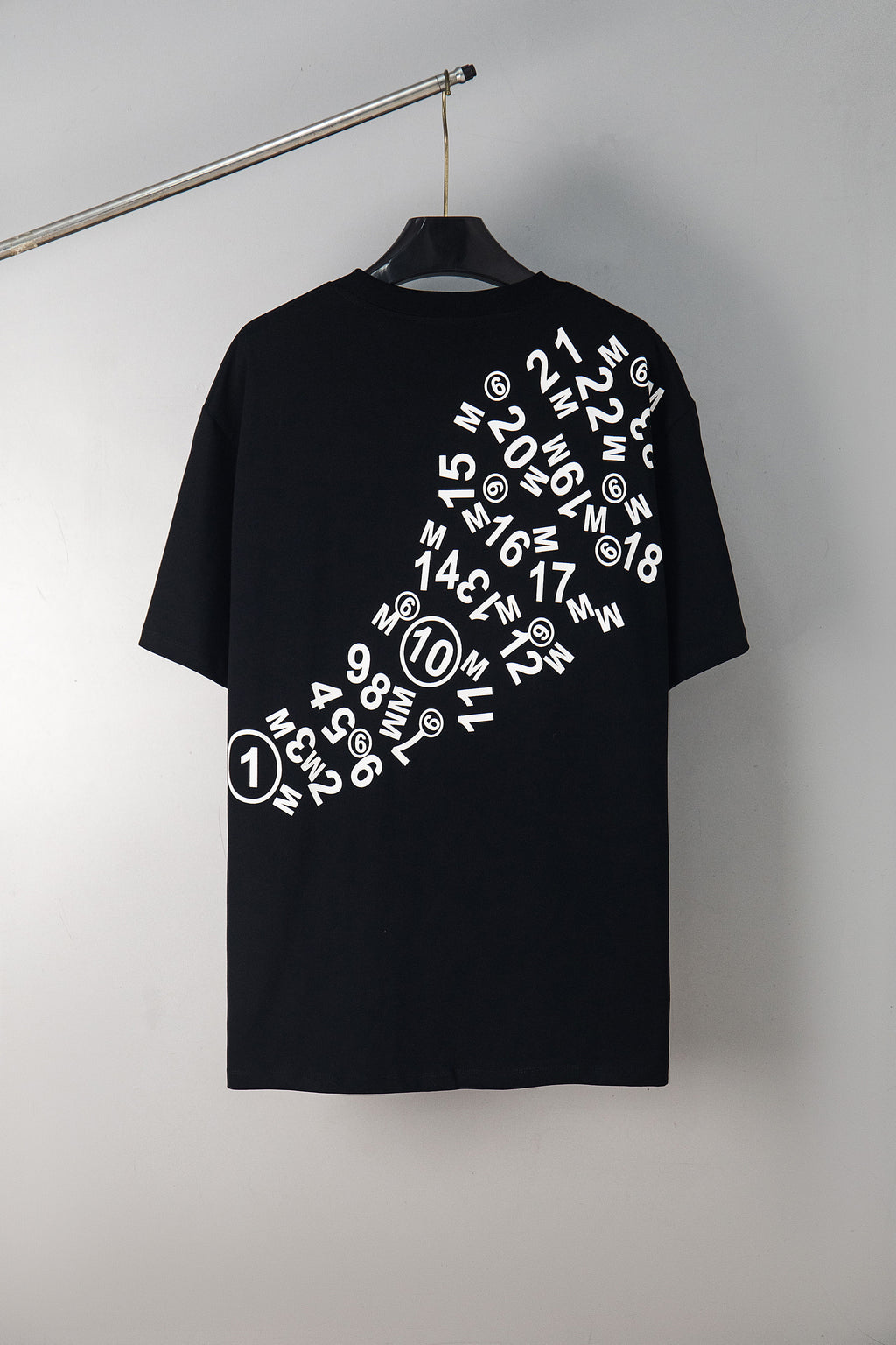 Black graphic T-shirt with circular number logo on chest