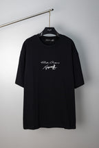 Black crewneck T-shirt with small script logo graphic at chest