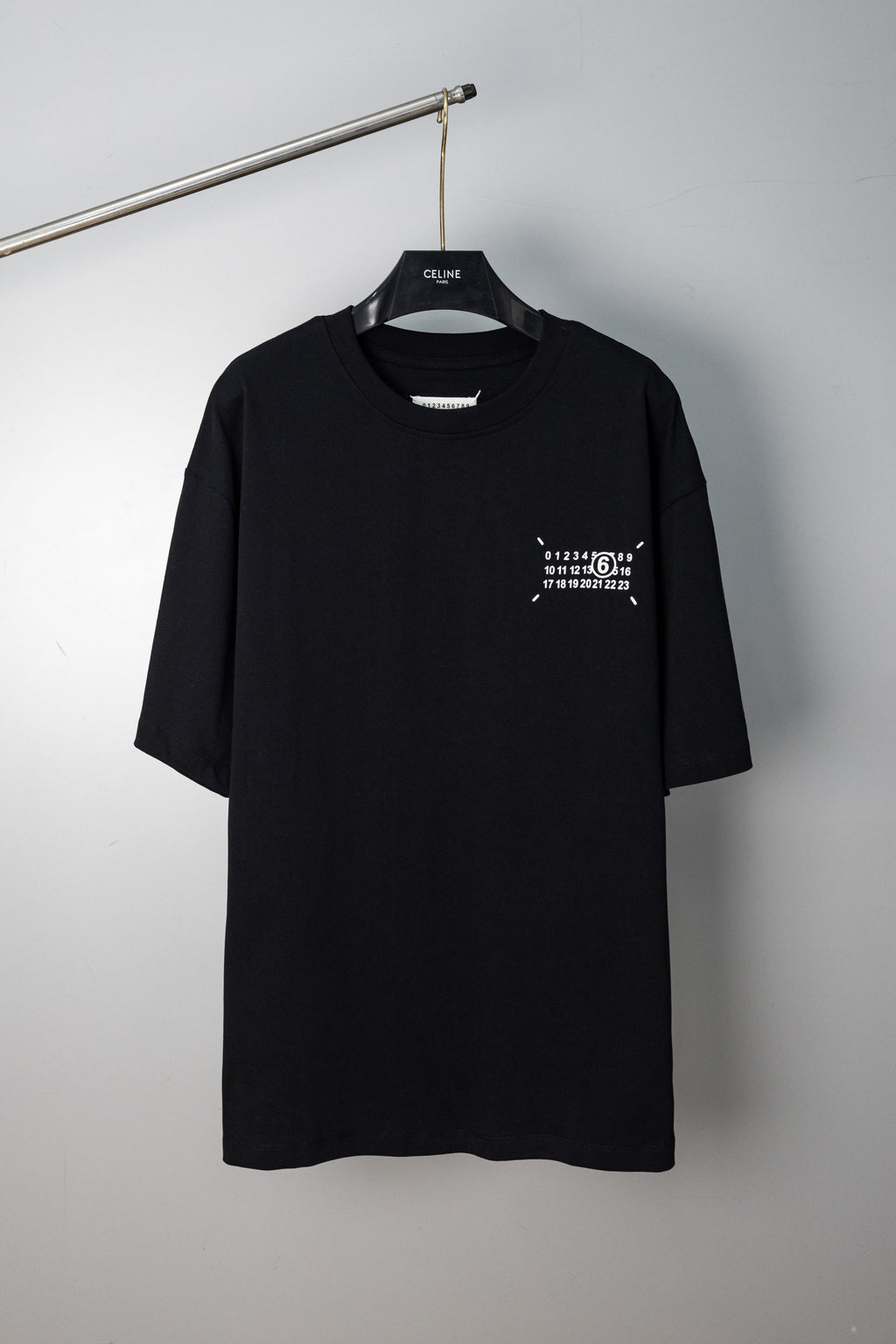 Black crew-neck T-shirt with small front numeric graphic print and short sleeves