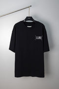 Black crew-neck T-shirt with small front numeric graphic print and short sleeves