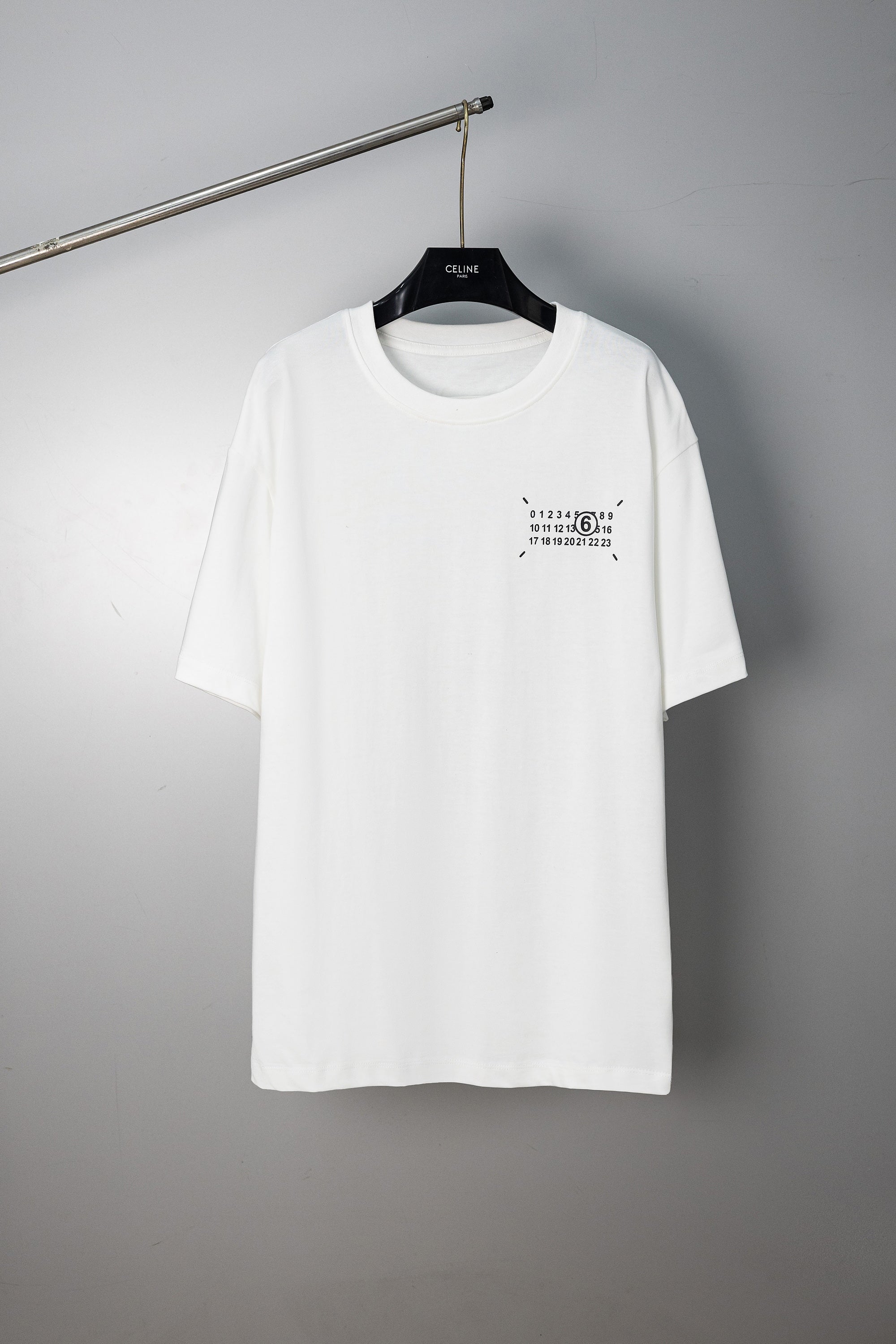 White crew-neck T-shirt with small front numeric graphic print and short sleeves