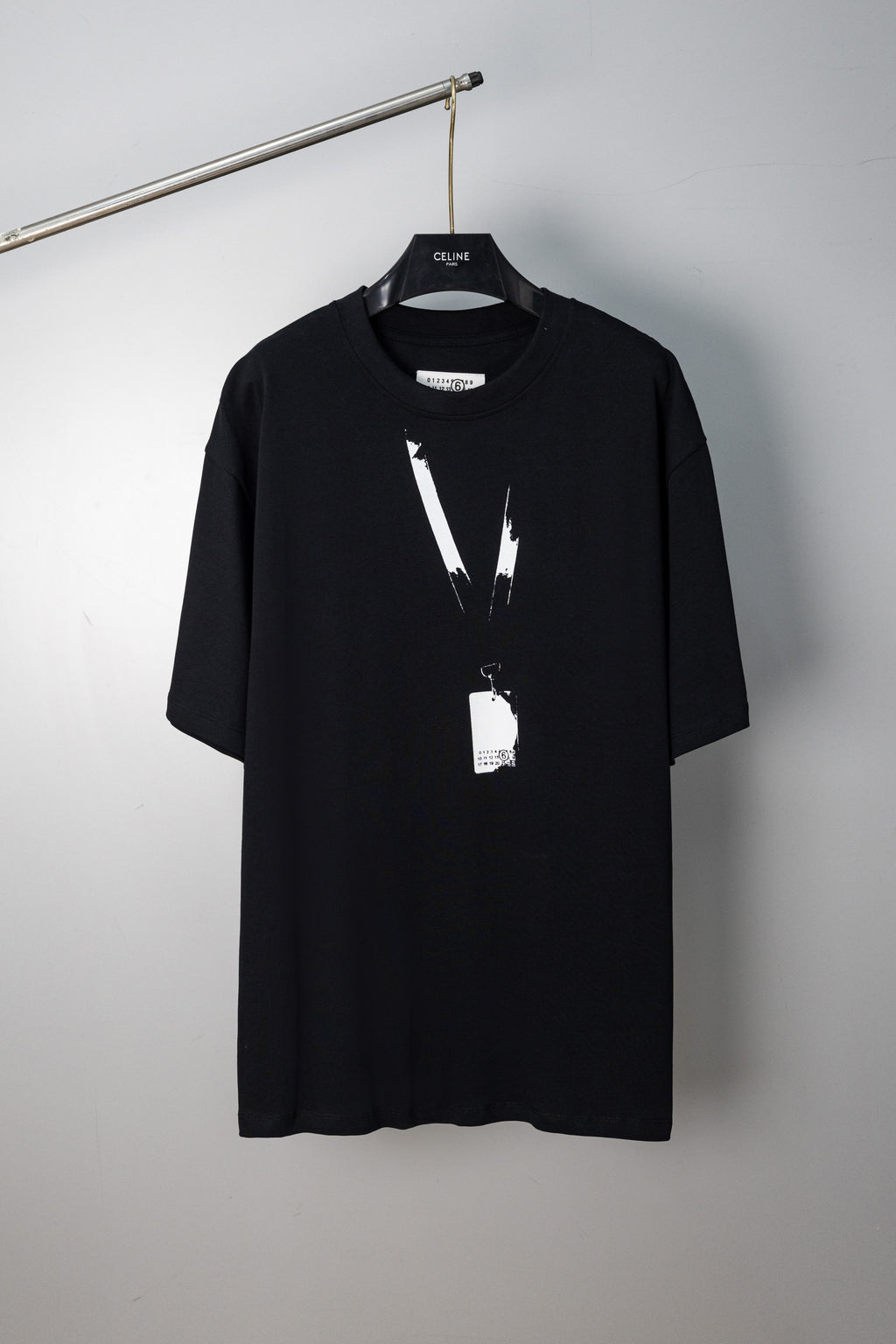 Black Maison Margiela T-shirt with abstract vertical paint graphic and hanging tag