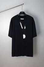 Black Maison Margiela T-shirt with abstract vertical paint graphic and hanging tag