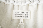 Close-up of interior label on white shorts with size and origin information