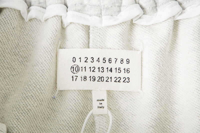Close-up of interior label on white shorts with size and origin information