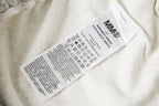 Close-up care label inside white shorts with washing and recycling symbols