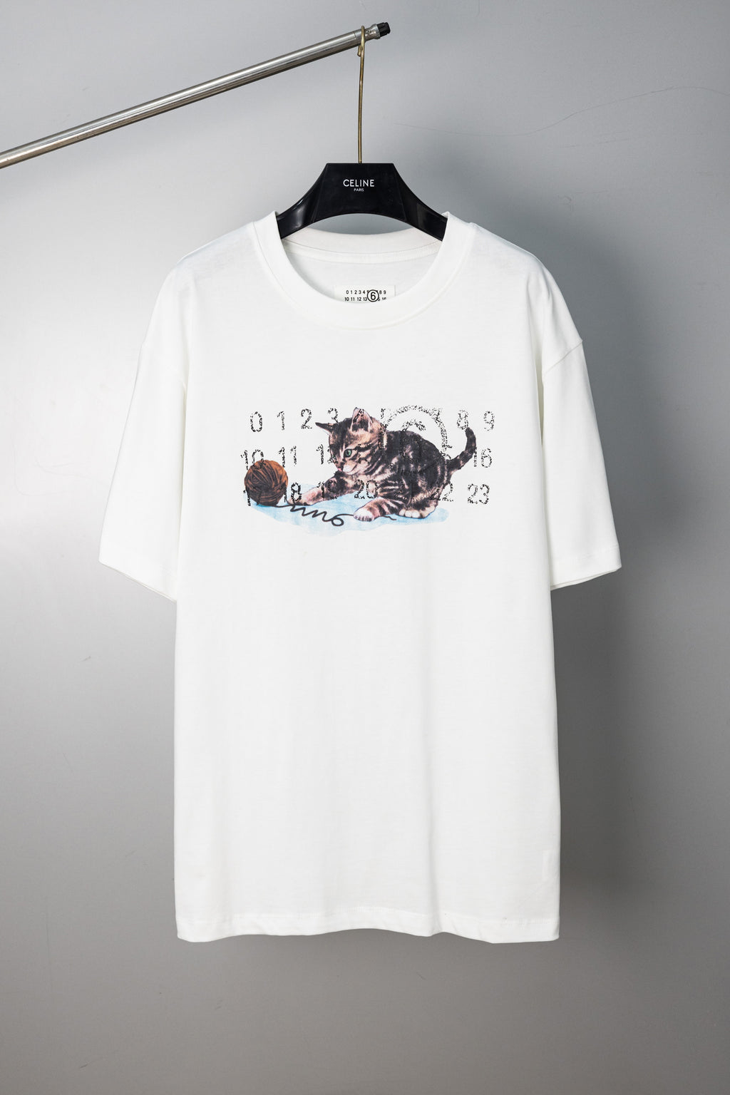 White crew-neck T-shirt with cat graphic print and numbered lettering