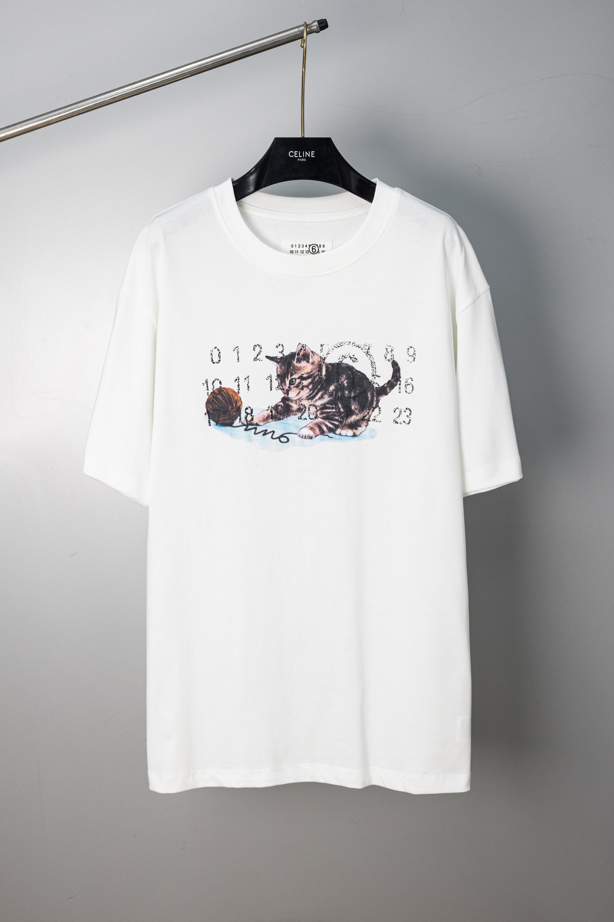 White crew-neck T-shirt with cat graphic print and numbered lettering