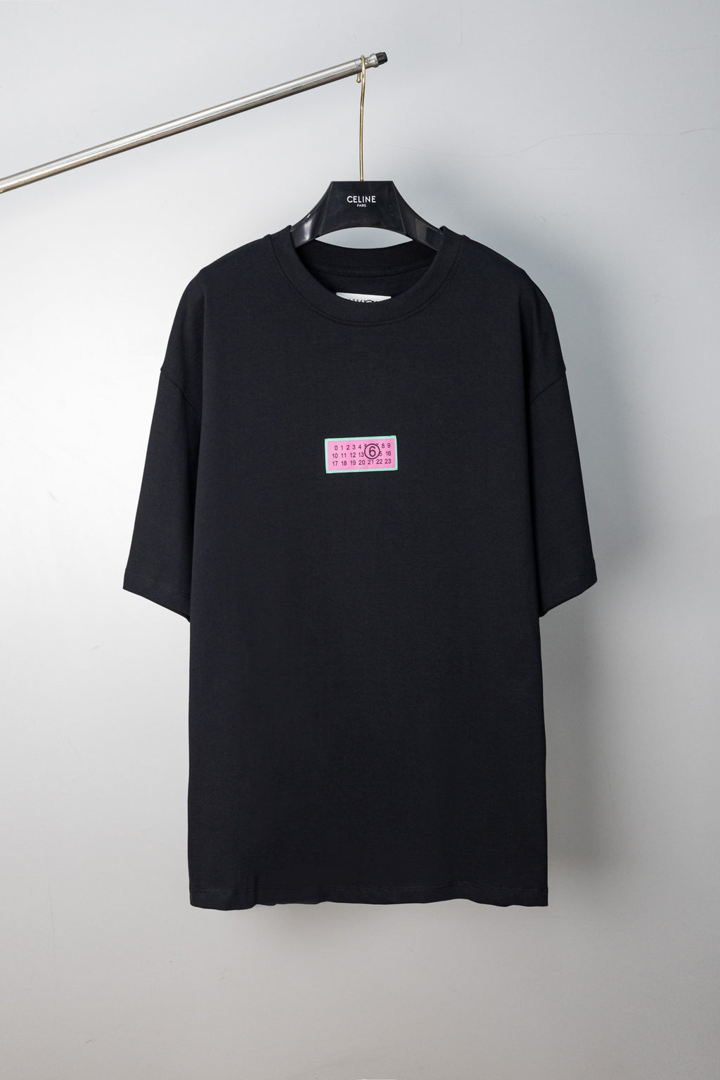 Black crewneck T-shirt with multicolor chest label