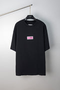 Black crewneck T-shirt with multicolor chest label