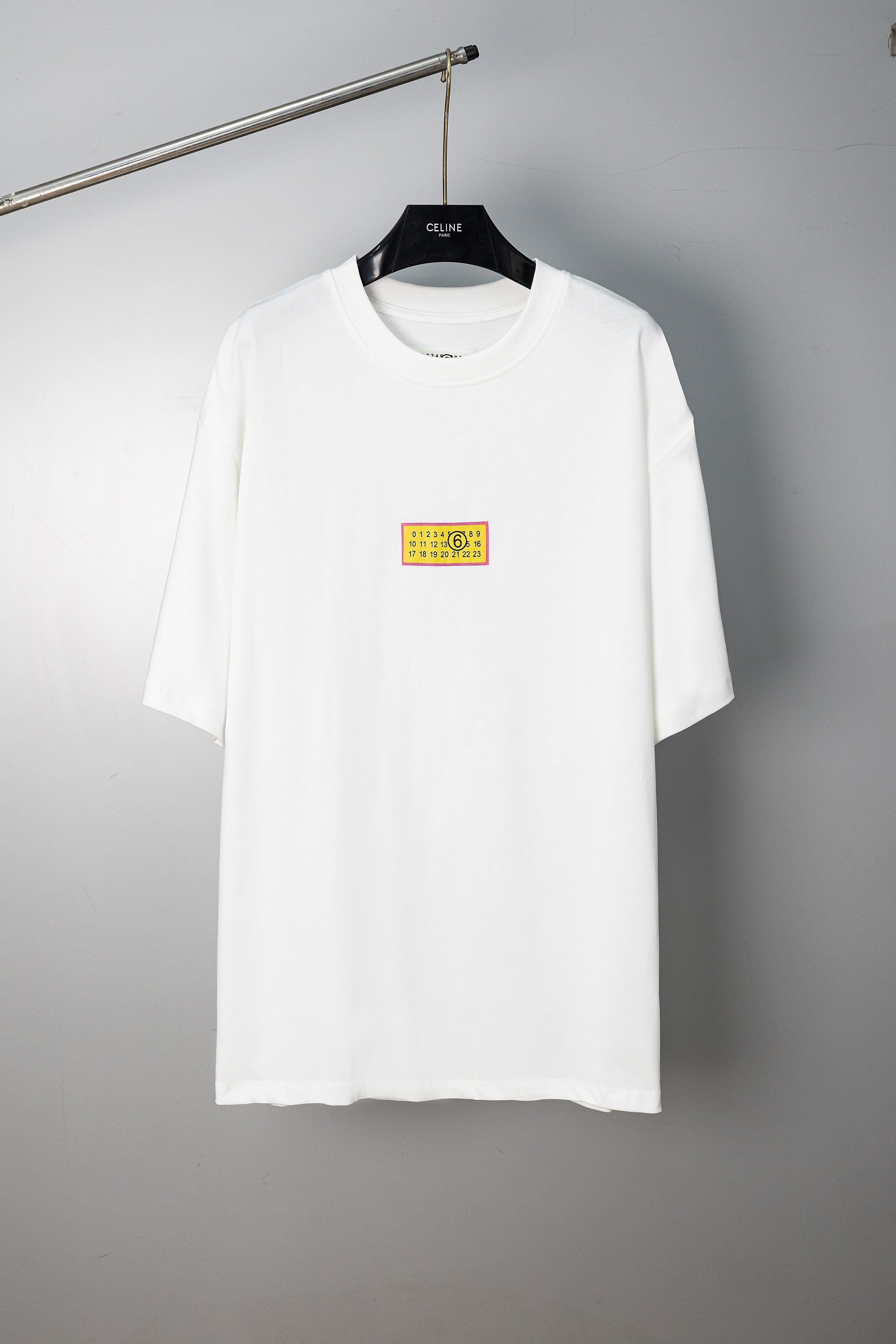 White crewneck T-shirt with multicolor chest label