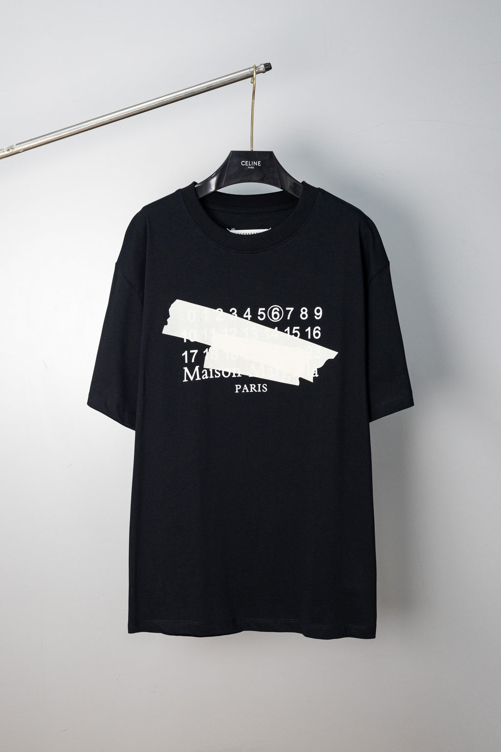 Black crew-neck T-shirt with Maison Margiela number and logo graphic on front