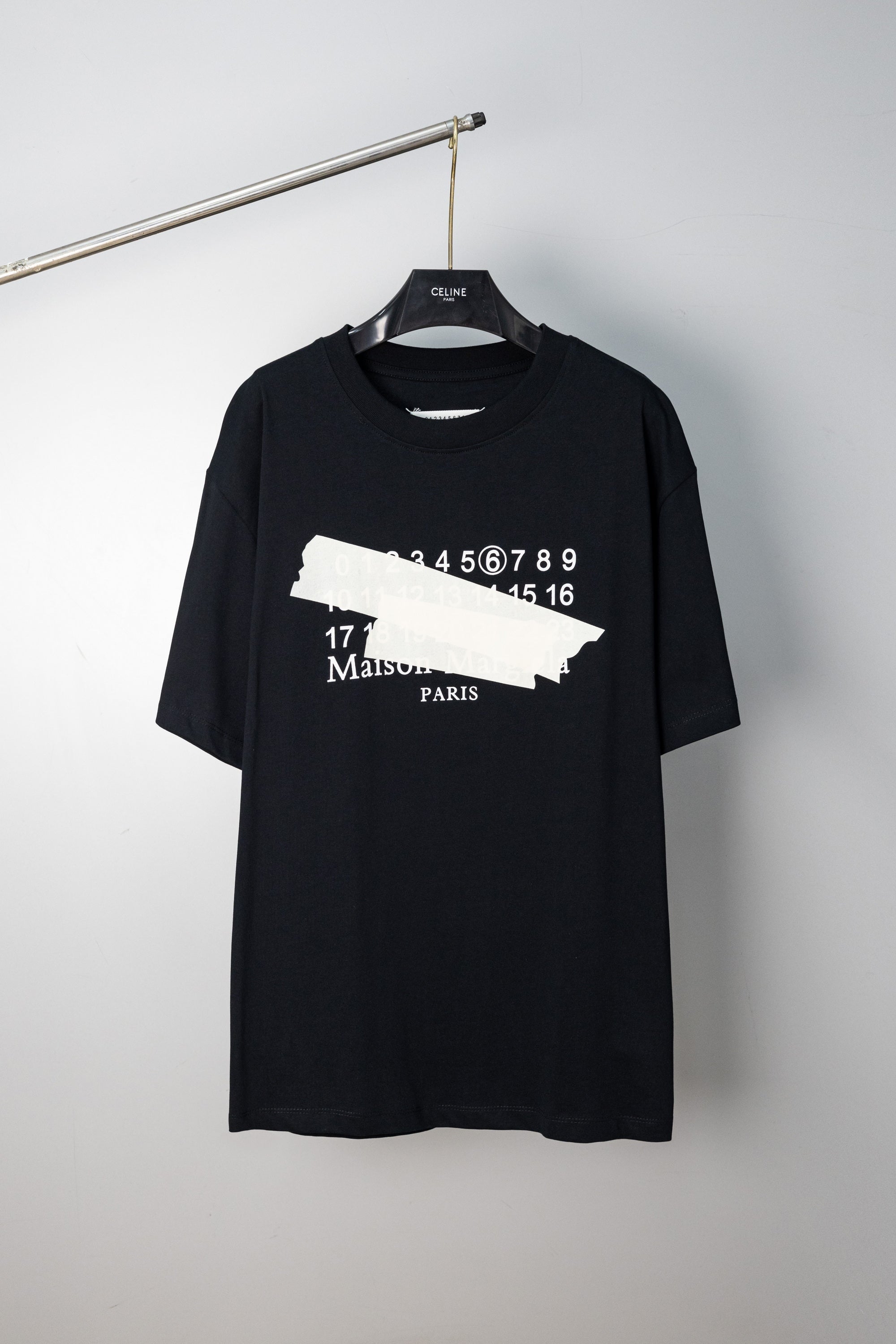 Black crew-neck T-shirt with Maison Margiela number and logo graphic on front