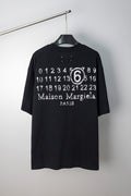 Black T-shirt with “Maison Margiela Paris” number 6 graphic print at chest