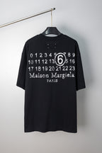Black T-shirt with “Maison Margiela Paris” number 6 graphic print at chest