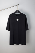 Maison Margiela black crew-neck T-shirt with small triangular logo on chest