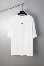 Maison Margiela white crew-neck T-shirt with small triangular logo on chest