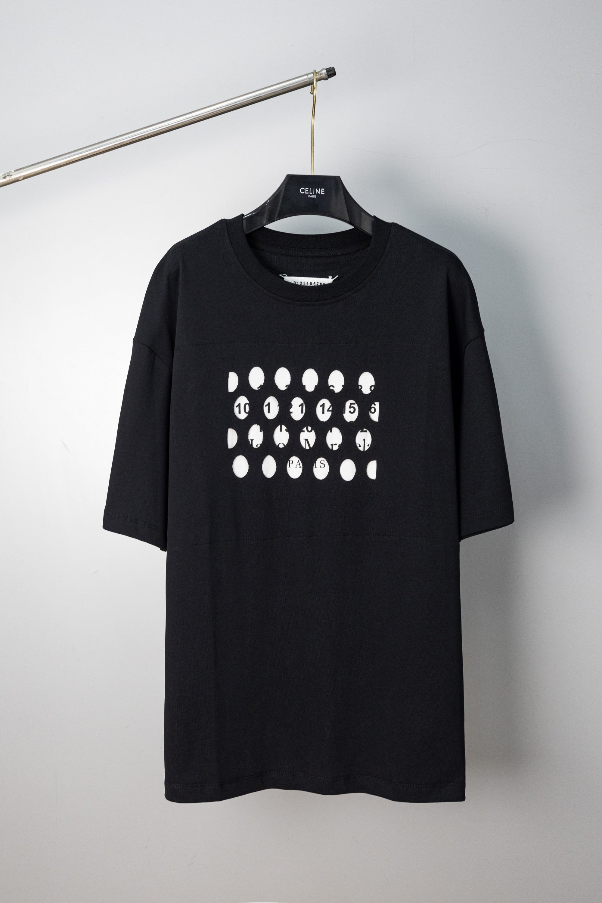 Black crewneck T-shirt with white dot logo graphic, short sleeves