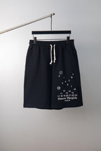 Black drawstring shorts with elastic waistband and number chart logo print