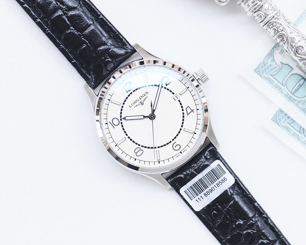 Longines wristwatch with white dial, black leather strap, silver-tone case, metal crown