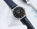 Longines wristwatch with black dial, silver-tone case, and dark blue leather strap