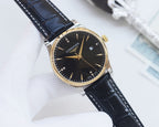 Longines wristwatch with black dial, gold-tone case, and dark blue leather strap