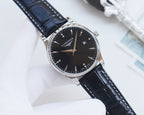 Longines wristwatch with black dial, silver-tone case, and dark blue leather strap