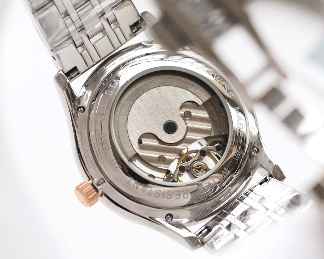 Open caseback of a stainless steel watch with visible mechanical movement